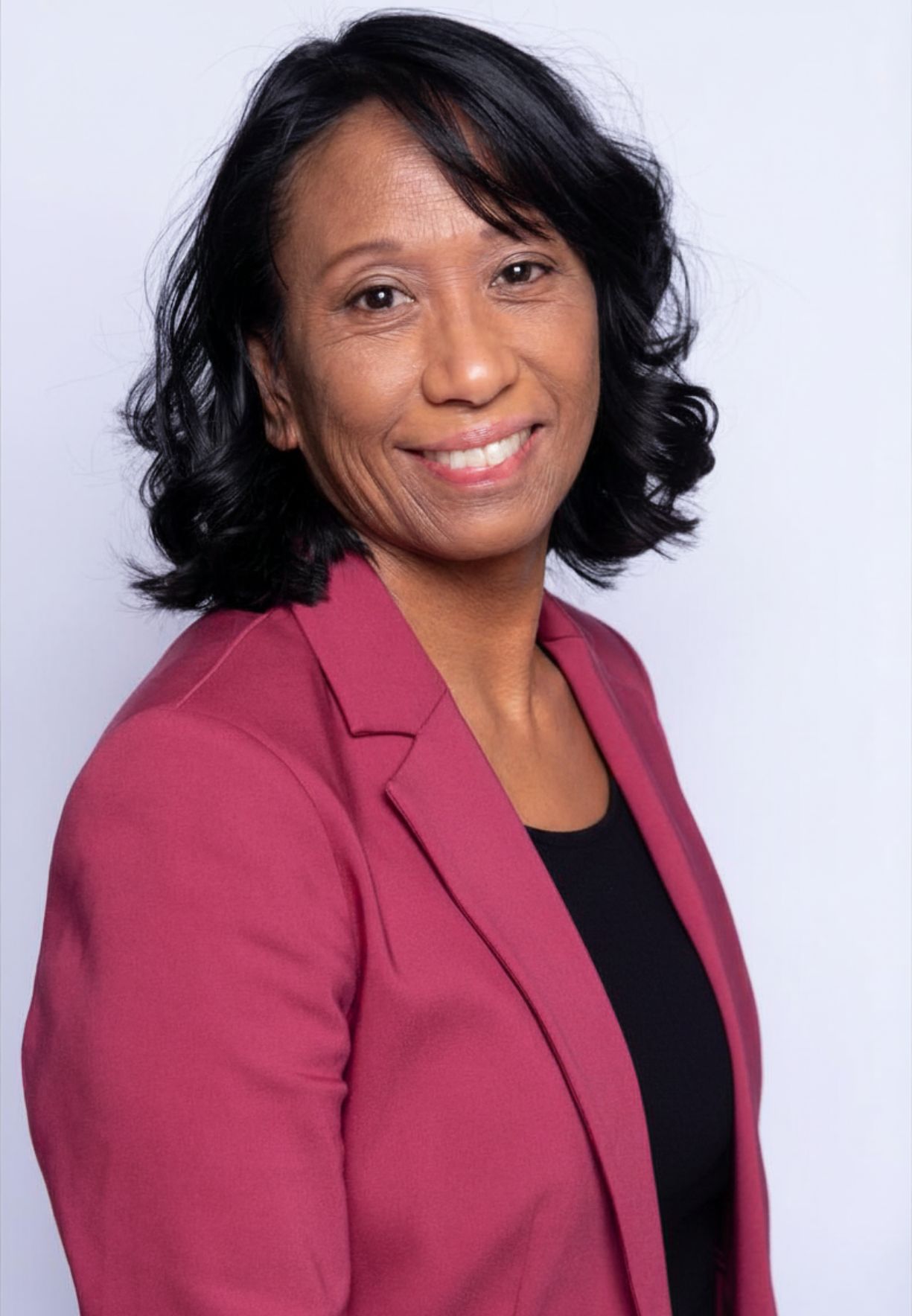 Headshot of Donna Laggui Crombie wearing a magenta blazer