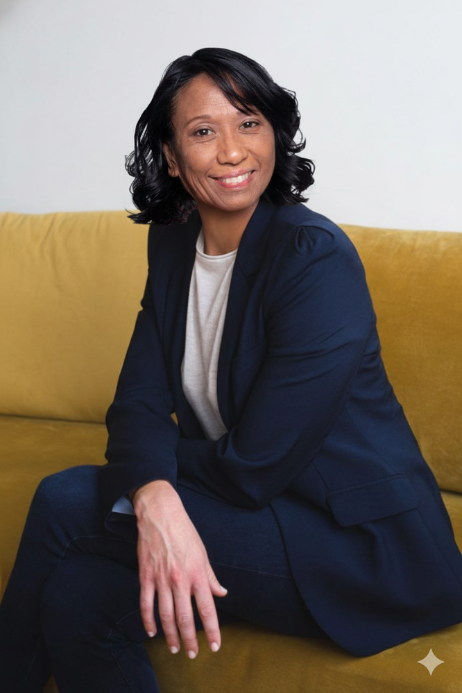 Donna Laggui Crombie smiling while seated on a sofa